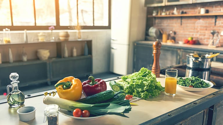 When should food preparation surfaces be cleaned and sanitized?